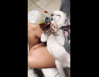 Girl bottle feeds white baby lion cub 