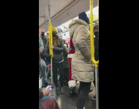 Guy in santa outfit gets off at subway stop