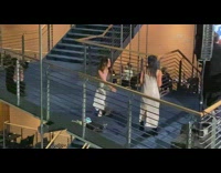 Two women in white dress dances at the stairs