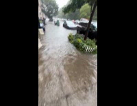 Person walks and crosses the flooded street