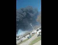 Thick black smoke in sky from fire 