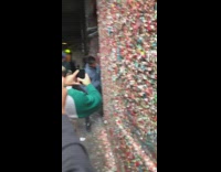 Guy blue sweater licks seattle gum wall