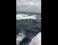 Large wave hit the window of boat