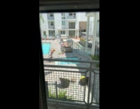 Man shirtless yellow cap exercise pool handrails