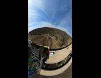 Man jumps on the truck on the highway and parachute glide down