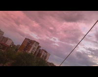 Purple clouds turned orange sunset buildings overcast