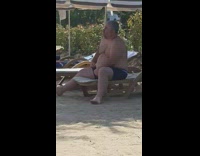 Shirtless guy sits pool chair breathes loudly