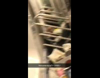 Homeless man puts all his trashbags and belongings inside a subway train
