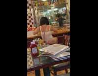 Lady sits at diner in leotard 