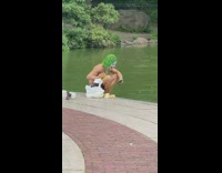 man with joker painted face feeds geese