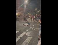 Man blue shirt lay middle of street night