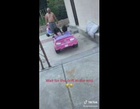 Toddler girl drifts in toy pink car 