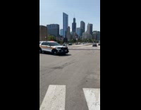 Police escort vehicles stop traffic for convoy