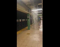 flood waters from hole in ceiling inside subway platform