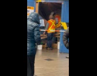 Subway station ceiling leaks water beside workers