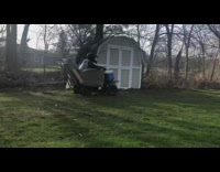 Guy drives recliner chair on wheels grass