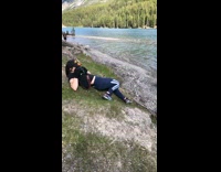 Three guys stand balance wood pole lake