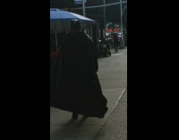 Batman walks past outdoor market 