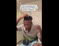 Guy uses red drill to twist hair 