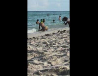 Woman green hair kneel butt shot beach
