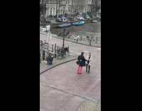 Couple dances in the middle of a bridge 