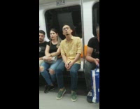 Man in yellow shirt green shoes starts singing out loud on the subway