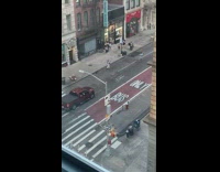 Woman in blue dress poses in the middle of the street