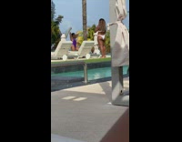 Woman purple onesie hand on hips pool