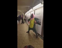 man green dinosaur outfit dancing pink mask