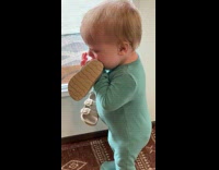 Baby on front door hold sandals cry