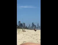 Guy black shorts lay beach buildings friend