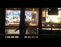 Drunk man dances in front of Taco Bell Cantina doors from inside