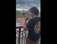 Guy blows bubble from horn and it flies around apartment 