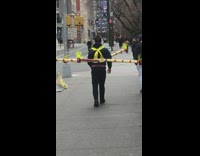 Guy wears long yellow sticks around body 