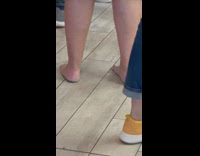 Lady waits in line barefoot inside restaurant 