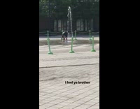 Guy stands in the middle of a fountain and lets water pour onto his back