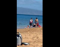 Woman pink bikini orange flower beach photoshoot