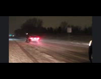 Lowered car plow snow on highway night