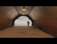 Red jacket lady sings under tunnel park 