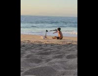 Teen guy lay on beach tripod sunset