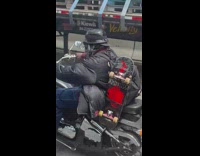 Man rides motorcycle skateboard on backpack