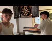 Guy shoots friend hand while playing darts 