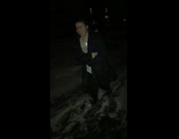 Girl walking on icy snowy ground slips and falls on her face