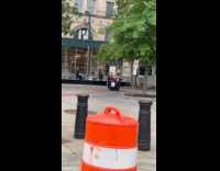 Woman on scooter protest performance on street