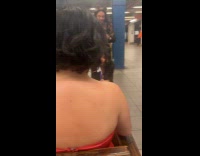 Collab Subway Creatures - Man standing holds snake watches woman singing