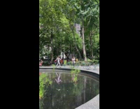 Woman skips on the edge of the water fountain