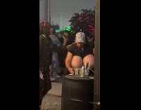 Man black dress wears huge boob costume