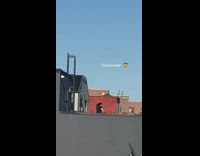 Black shirt guy cracks whip outside rooftop 