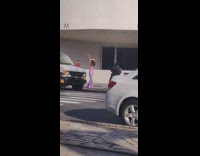 Girl striped pink blue shirt dances sidewalk