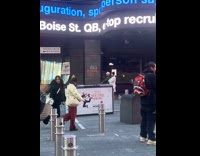 Two women dances together at Times Square